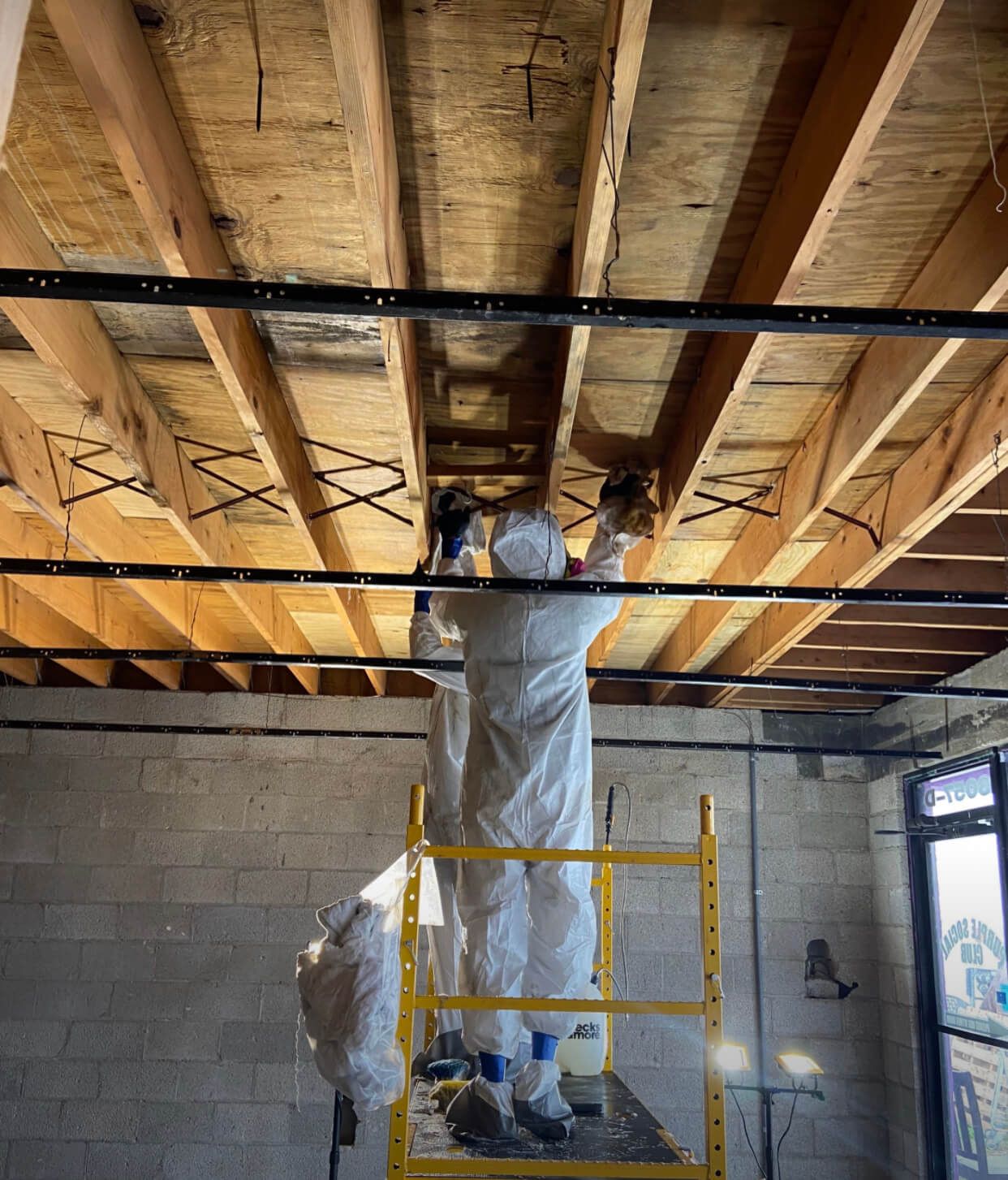 Enviro Peroxide pray and wipe. Cleaner plywood at wall has been treated. Darker are treatment being done.